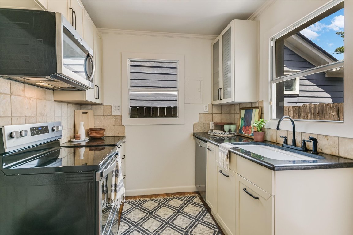 1110 West 22nd Street, Unit 16 Austin, TX 78705 - Photo 3 of 21 a kitchen with a sink stove and microwave