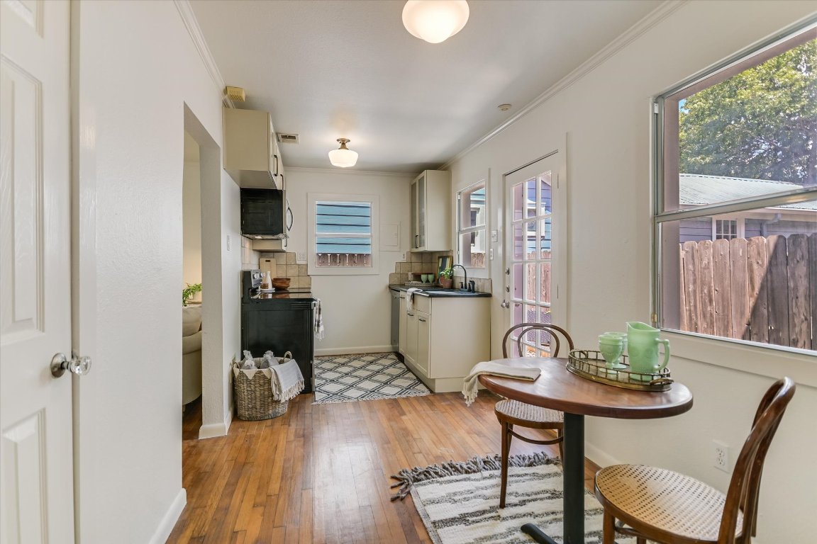 1110 West 22nd Street, Unit 16 Austin, TX 78705 - Photo 4 of 21 a view of a dining room with furniture window and wooden floor