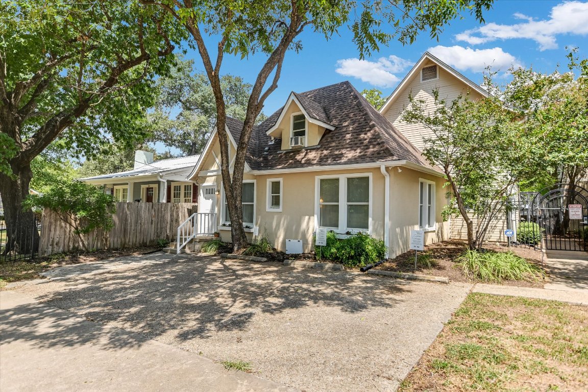 1110 West 22nd Street, Unit 16 Austin, TX 78705 - Photo 7 of 21 a front view of a house with a yard and potted plants