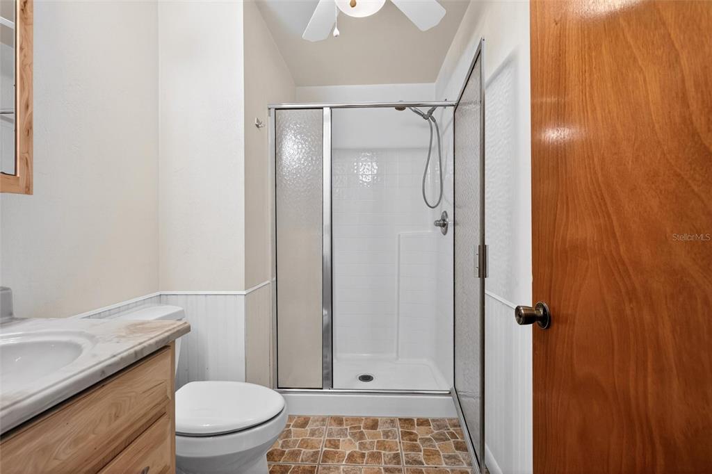 47 Carol Road Ormond Beach, FL 32176 - Photo 13 of 54 a bathroom with a granite countertop shower and a toilet