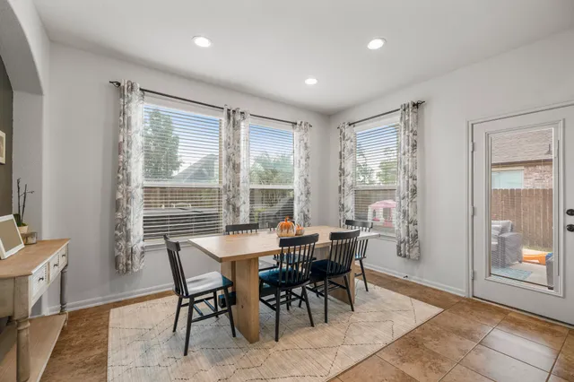 a bedroom with a bed a couch and a flat screen tv