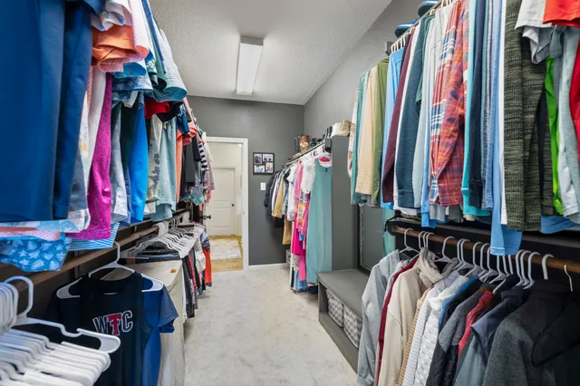 a bedroom with furniture and a flat screen tv