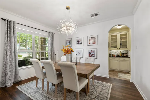 a view of a dining room with furniture wooden floor and chandelier