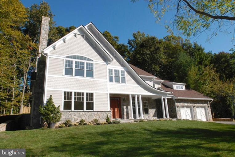 8539 Howell Road Bethesda, MD 20817 - Photo 1 of 22 a front view of a house with a yard