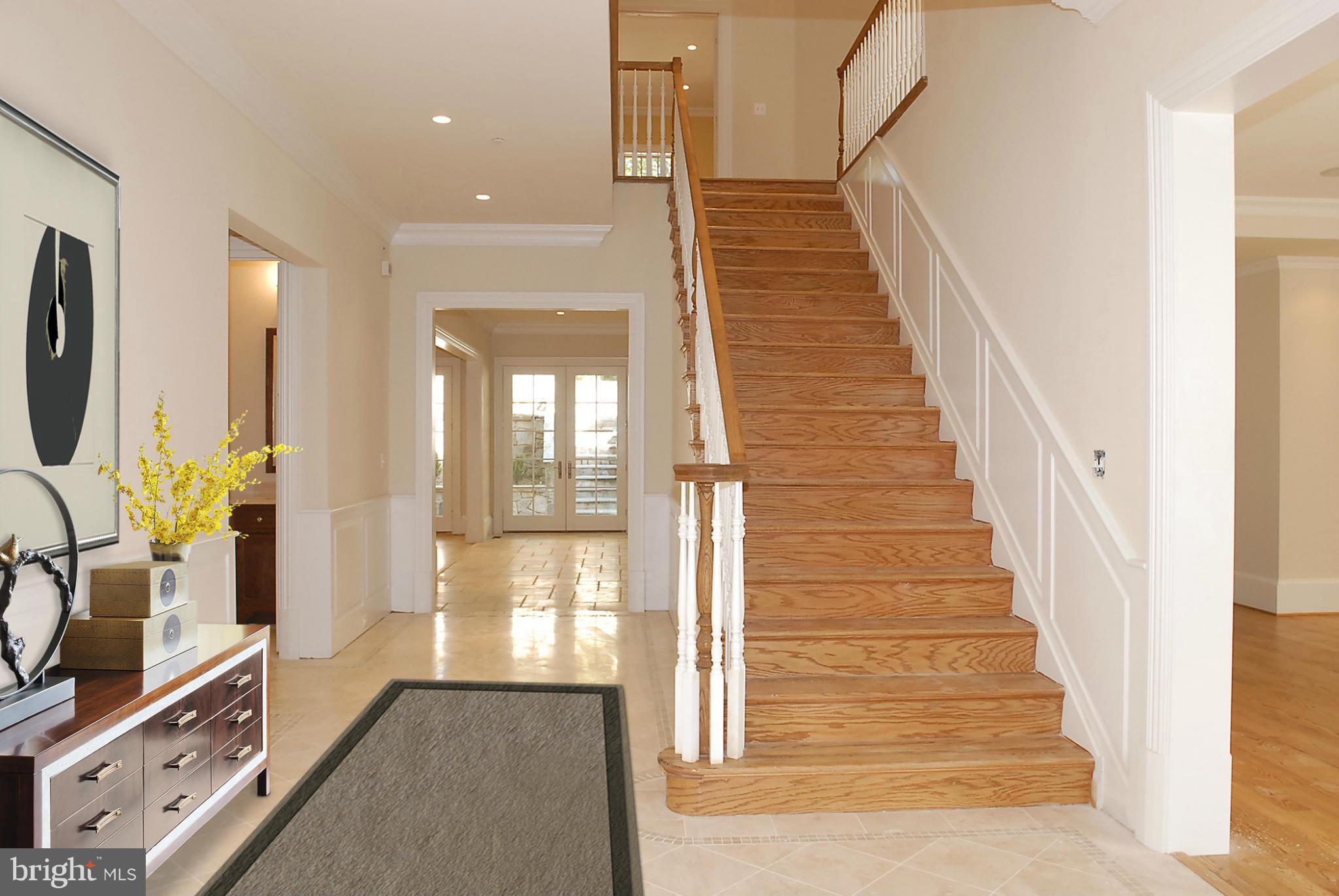 8539 Howell Road Bethesda, MD 20817 - Photo 2 of 22 a view of a hallway with wooden floor and staircase
