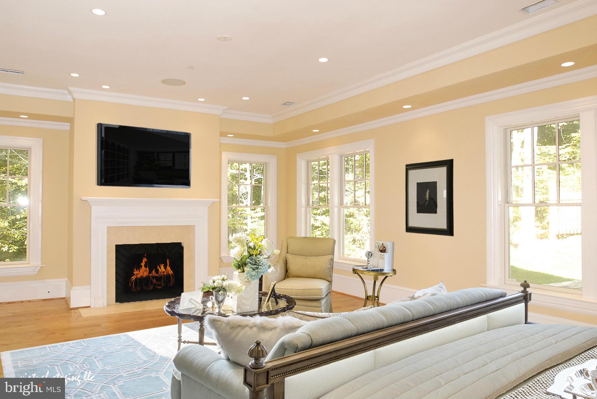 8539 Howell Road Bethesda, MD 20817 - Photo 11 of 22 a living room with furniture a fireplace and a flat screen tv