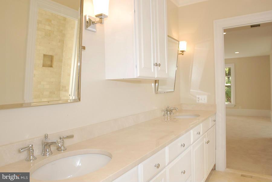 8539 Howell Road Bethesda, MD 20817 - Photo 19 of 22 a bathroom with a sink and a mirror