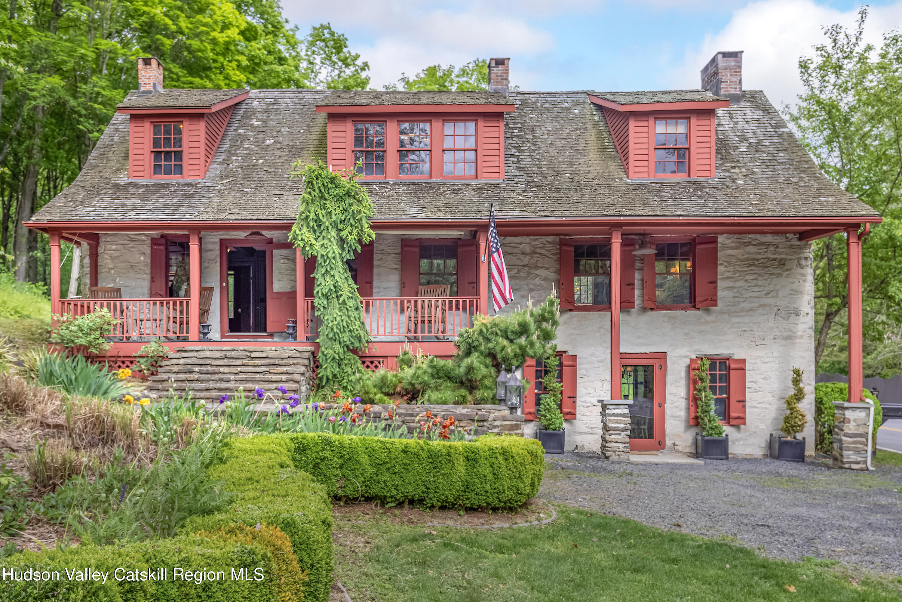 front view of a brick house with a yard