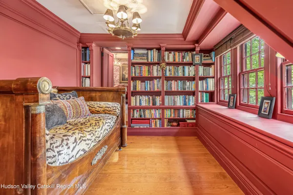 a bedroom with a bed and a book shelf