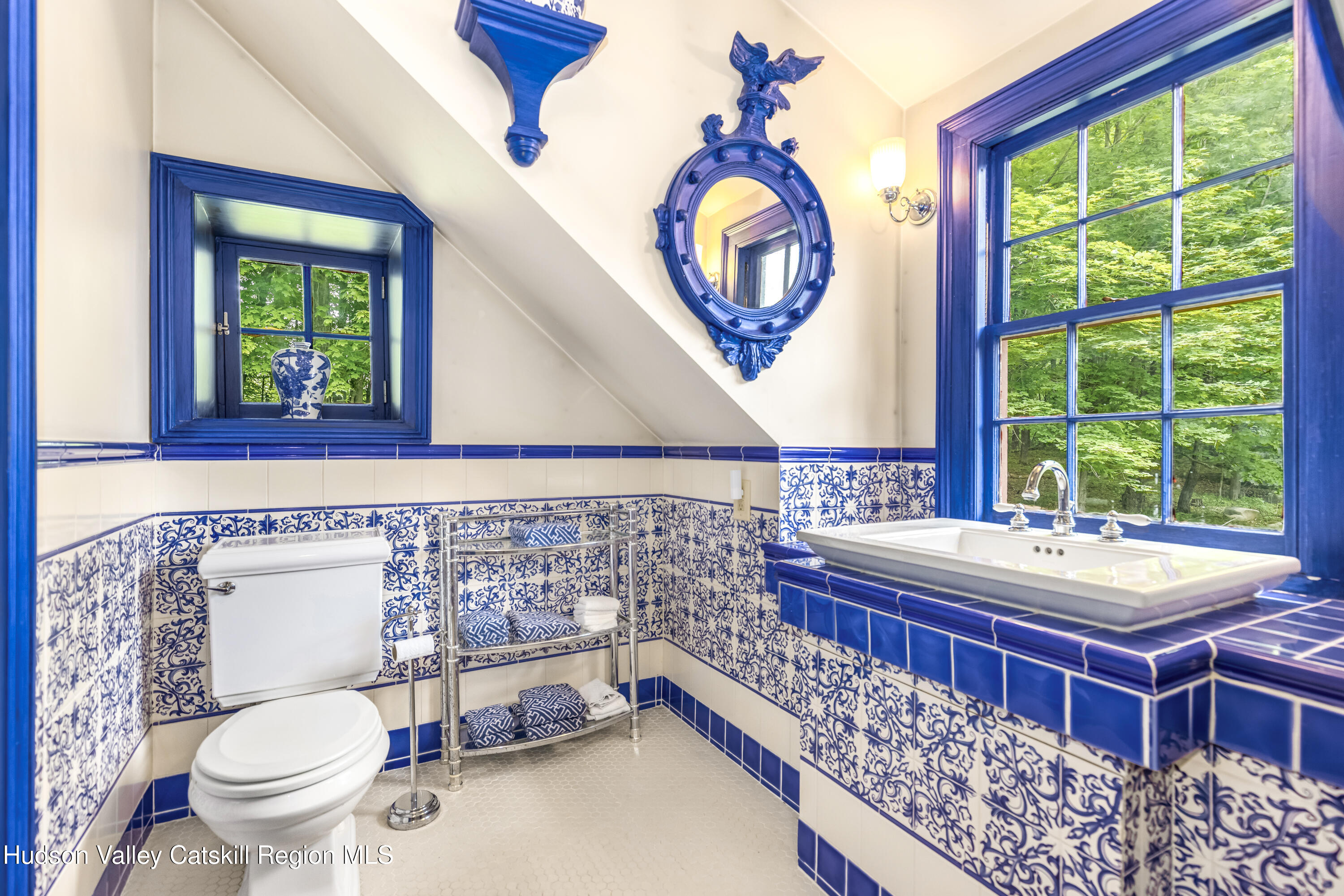 1282 Old Post Road New Paltz, NY 12561 - Photo 43 of 49 a bathroom with a toilet sink and mirror