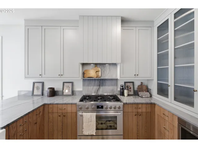 a kitchen with a white cabinets and window