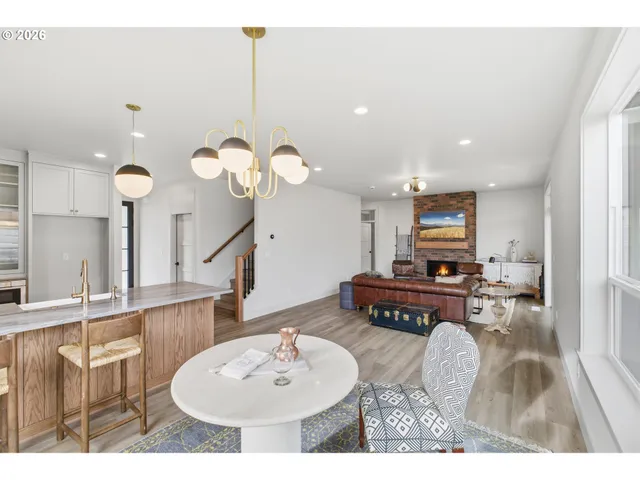 a living room with furniture a mirror and white walls
