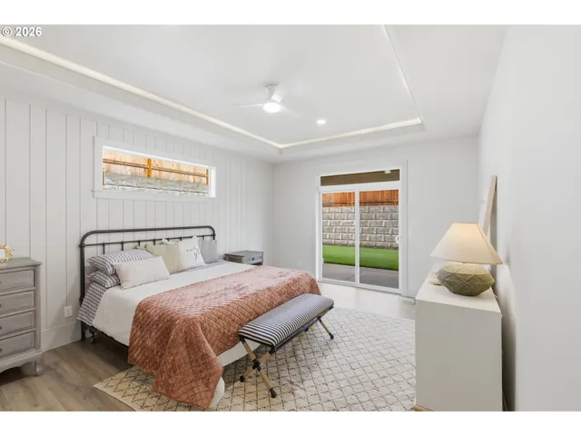 a bedroom with a bed a couch and a window