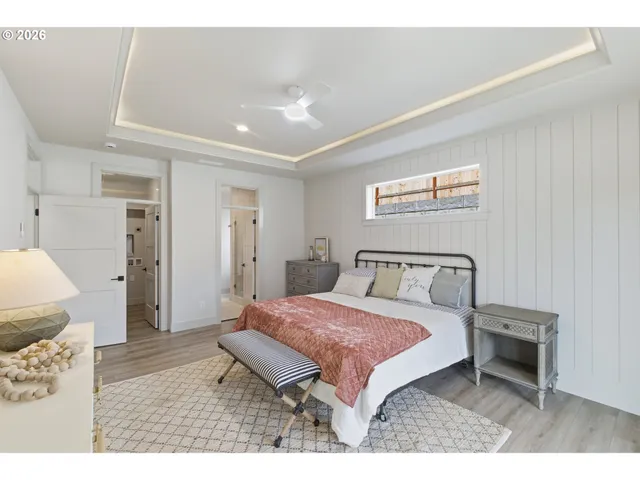 a bedroom with a bed a mirror and a desk