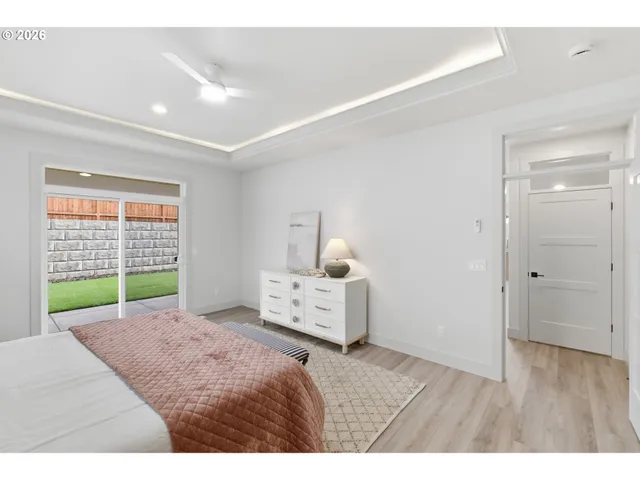 a bedroom with a bed and a large window