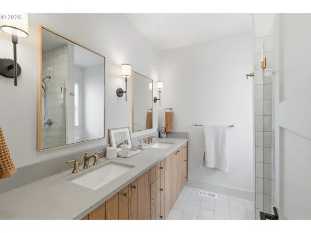a bathroom with a double vanity sink mirror and double