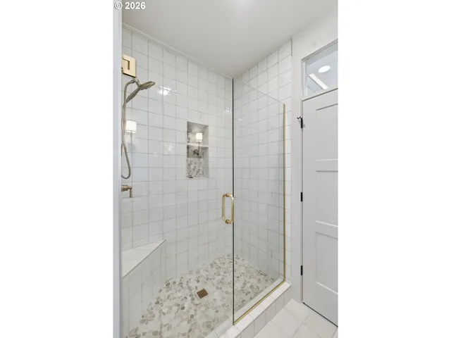a bathroom with a glass shower door