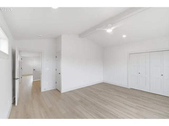 a view of an empty room and wooden floor