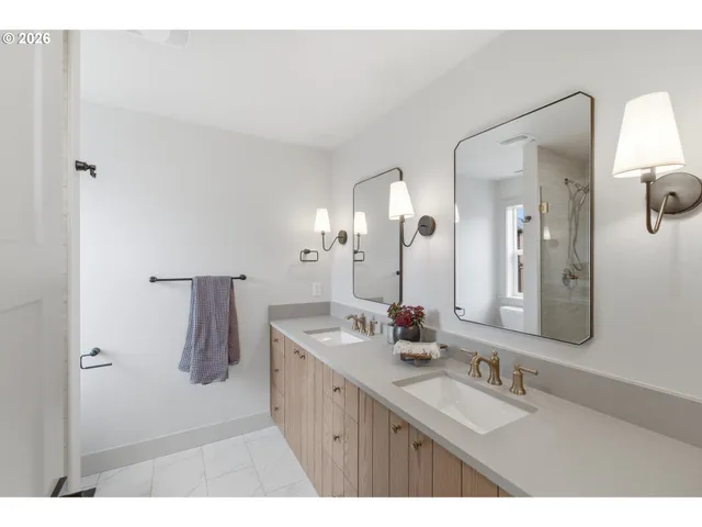 a bathroom with a double vanity sink and a mirror