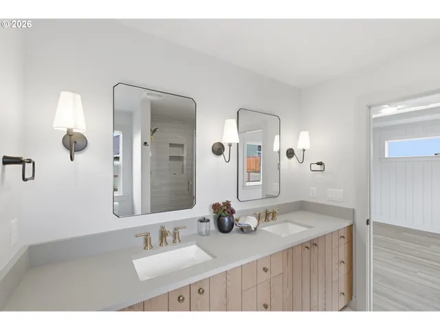 a bathroom with double vanity sinks and a mirror