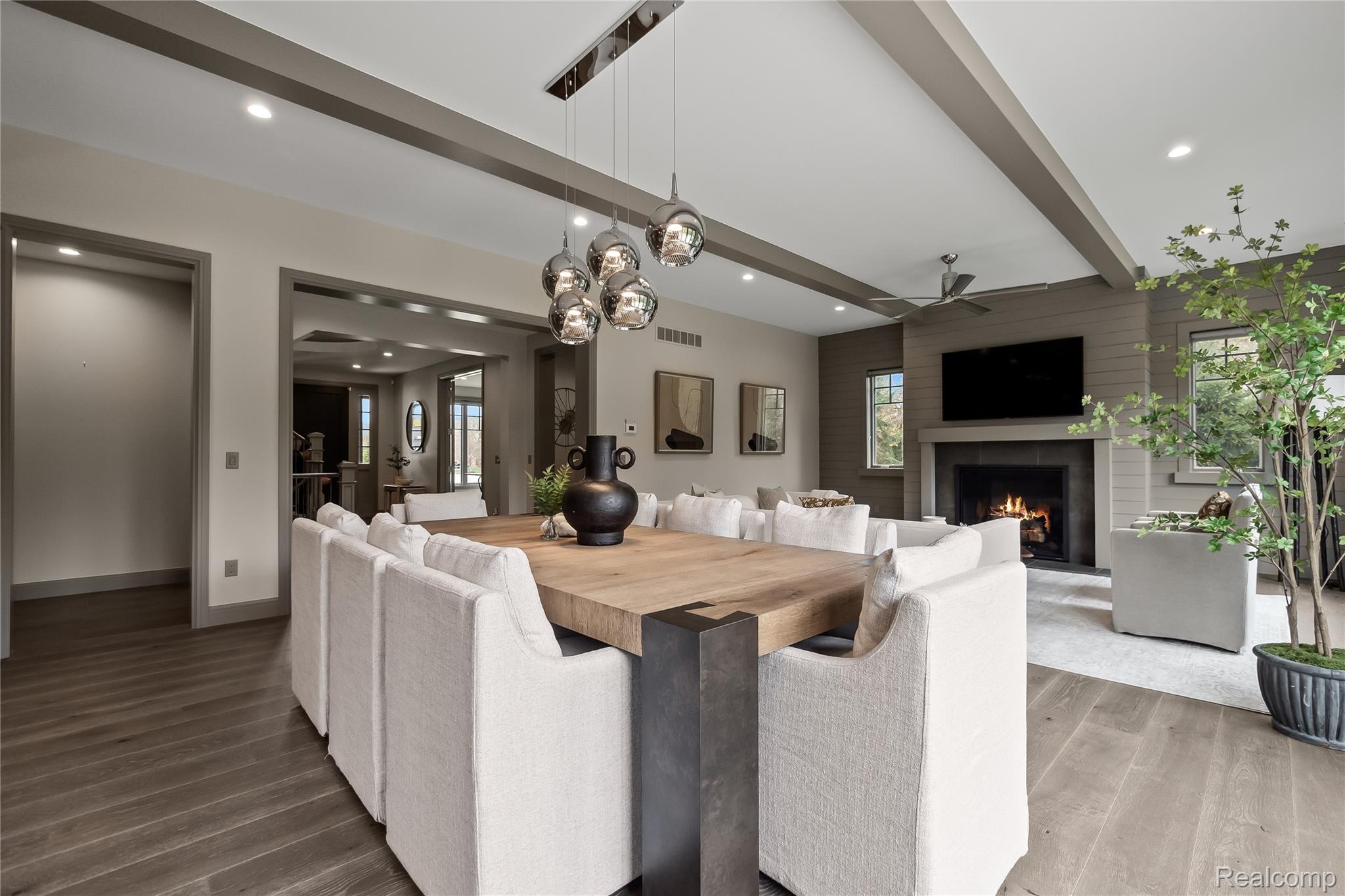 3824 Poppleton Street Troy, MI 48084 - Photo 10 of 51 Dining area featuring wood finished floors, recessed lighting, a lit fireplace, beam ceiling, and ceiling fan