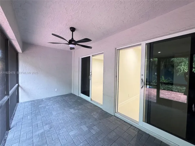 a view of a livingroom with a ceiling fan and window