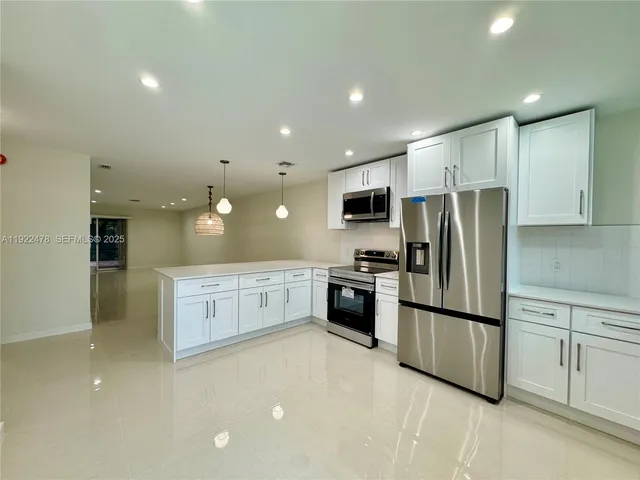 a kitchen with cabinets and stainless steel appliances