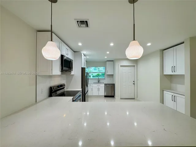 a view of a kitchen with microwave and cabinets