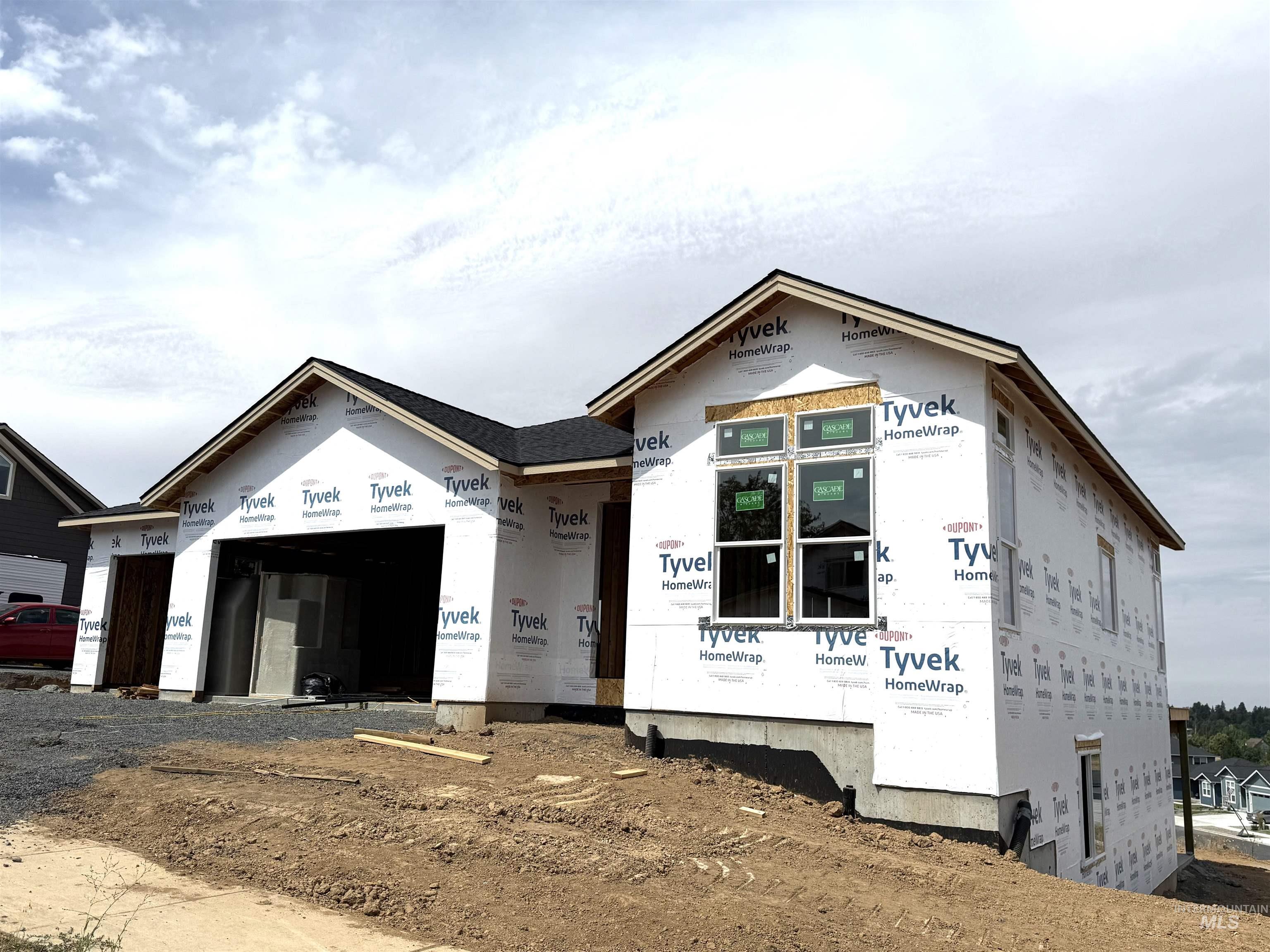 Property under construction featuring an attached garage