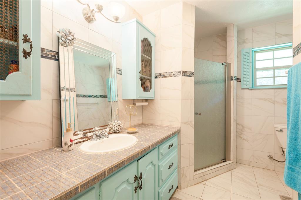 10289 County Road 578 Blue Ridge, TX 75424 - Photo 16 of 39 a bathroom with a sink and a mirror