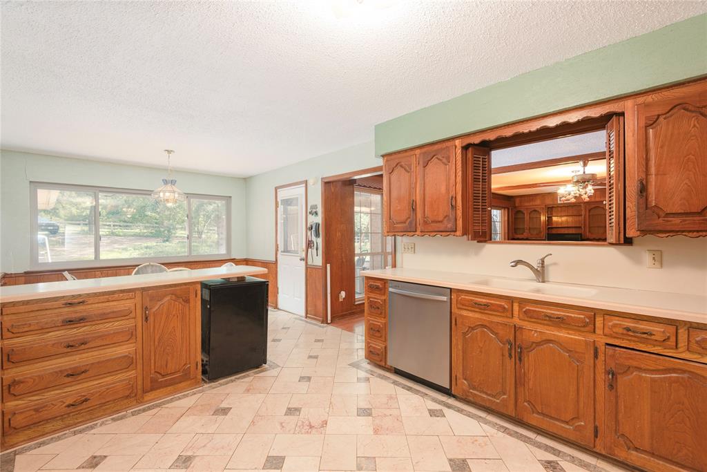 10289 County Road 578 Blue Ridge, TX 75424 - Photo 19 of 39 a large kitchen with wooden cabinets and a sink