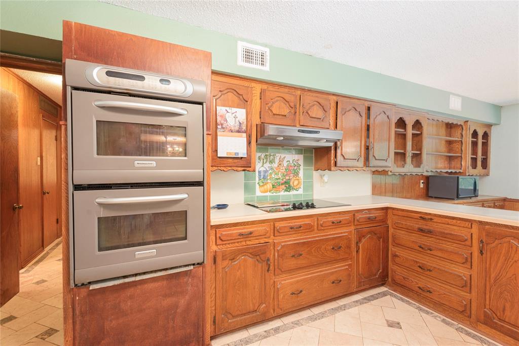 10289 County Road 578 Blue Ridge, TX 75424 - Photo 20 of 39 a kitchen with granite countertop a stove top oven microwave and cabinets