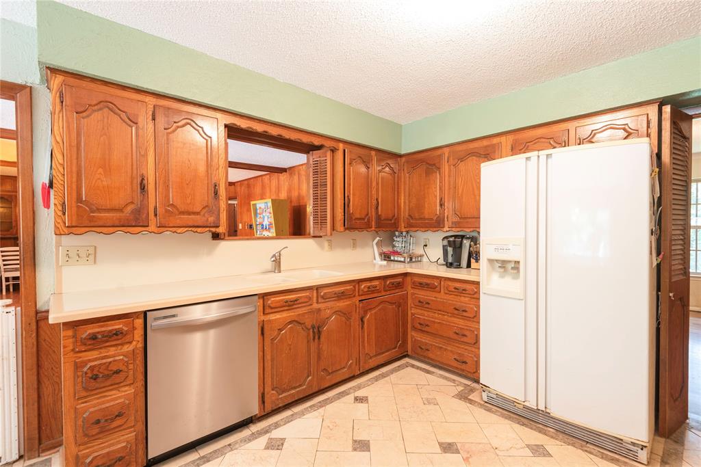 10289 County Road 578 Blue Ridge, TX 75424 - Photo 21 of 39 a kitchen with stainless steel appliances granite countertop a refrigerator and a sink