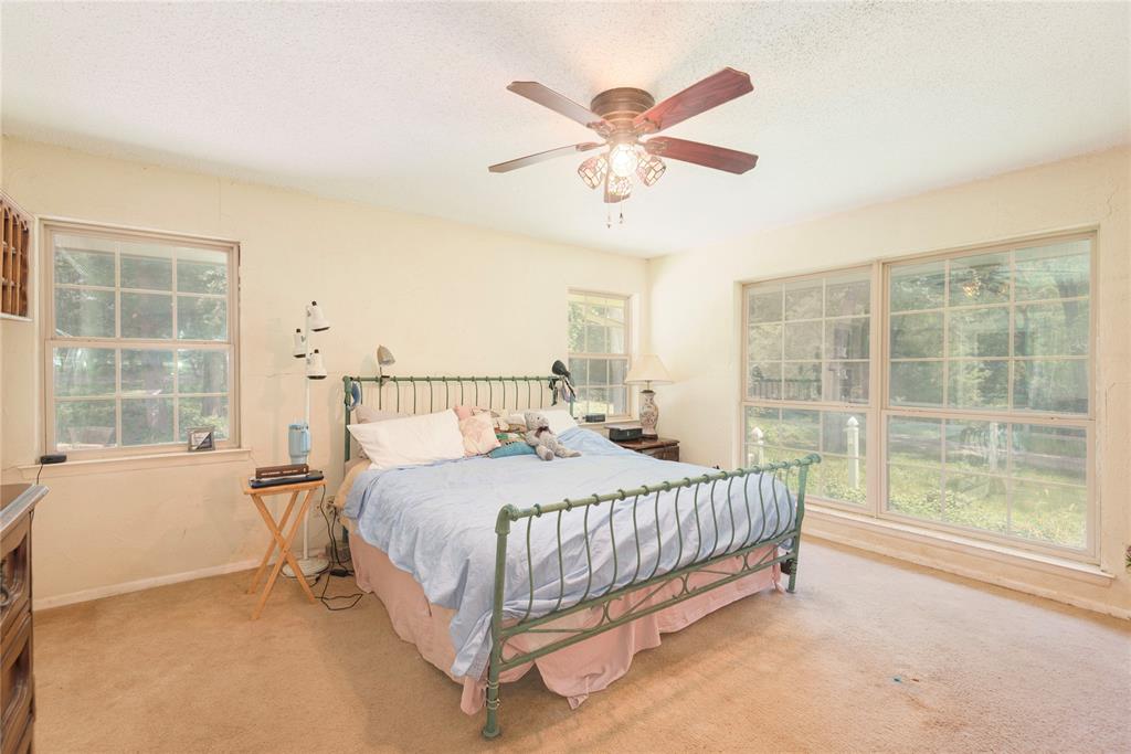 10289 County Road 578 Blue Ridge, TX 75424 - Photo 28 of 39 a bedroom with a bed and a large window