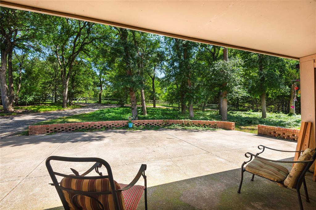 10289 County Road 578 Blue Ridge, TX 75424 - Photo 39 of 39 a view of a patio with a table chairs and a backyard