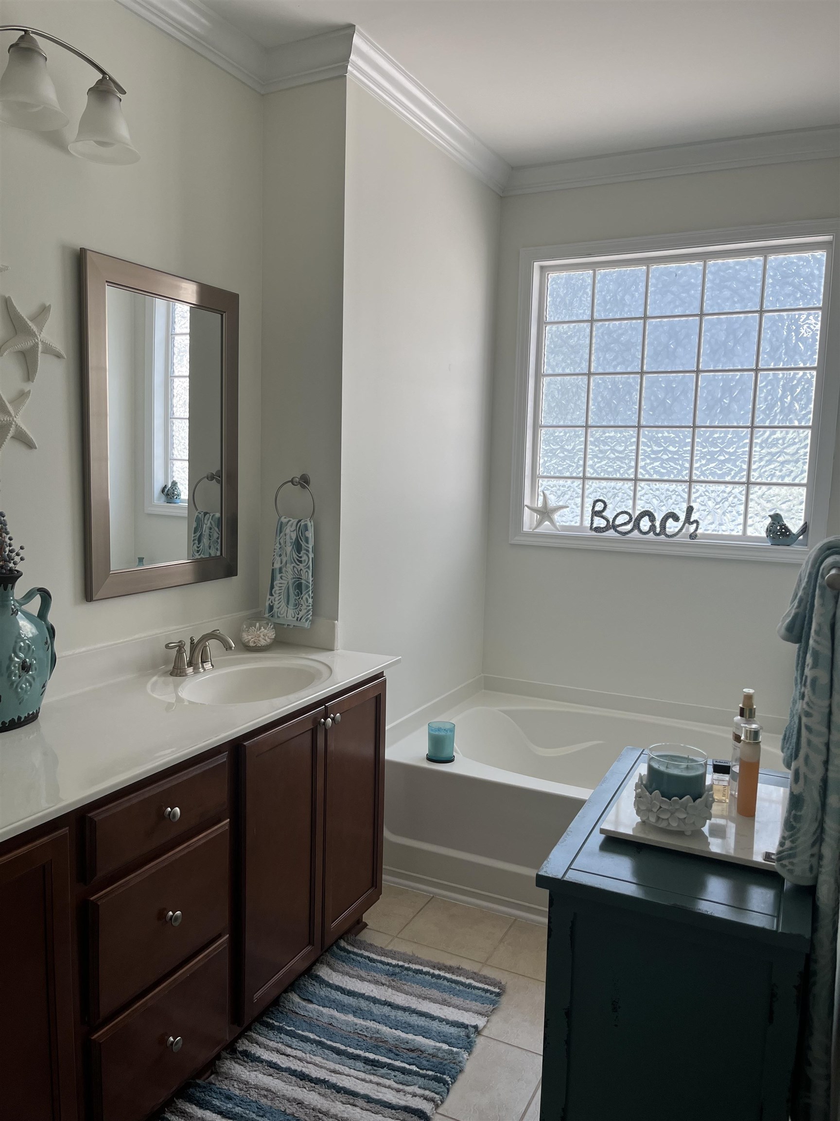 151 Coral Beach Circle Myrtle Beach, SC 29575 - Photo 20 of 40 Full bathroom featuring vanity, a bath, ornamental molding, light tile patterned floors, and plenty of natural light