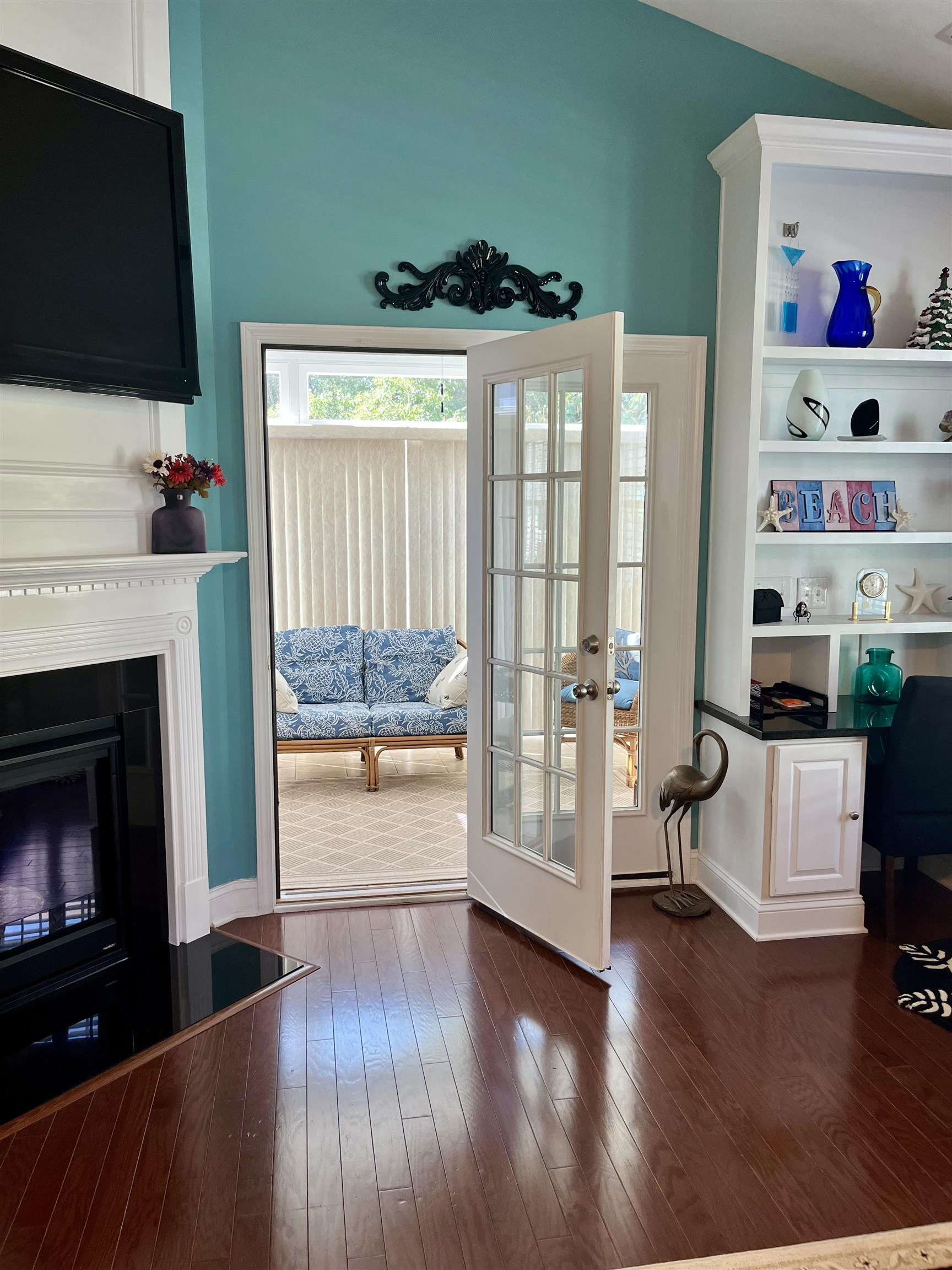 151 Coral Beach Circle Myrtle Beach, SC 29575 - Photo 29 of 40 Entryway with hardwood / wood-style flooring, a fireplace, an office area, french doors, and a high ceiling