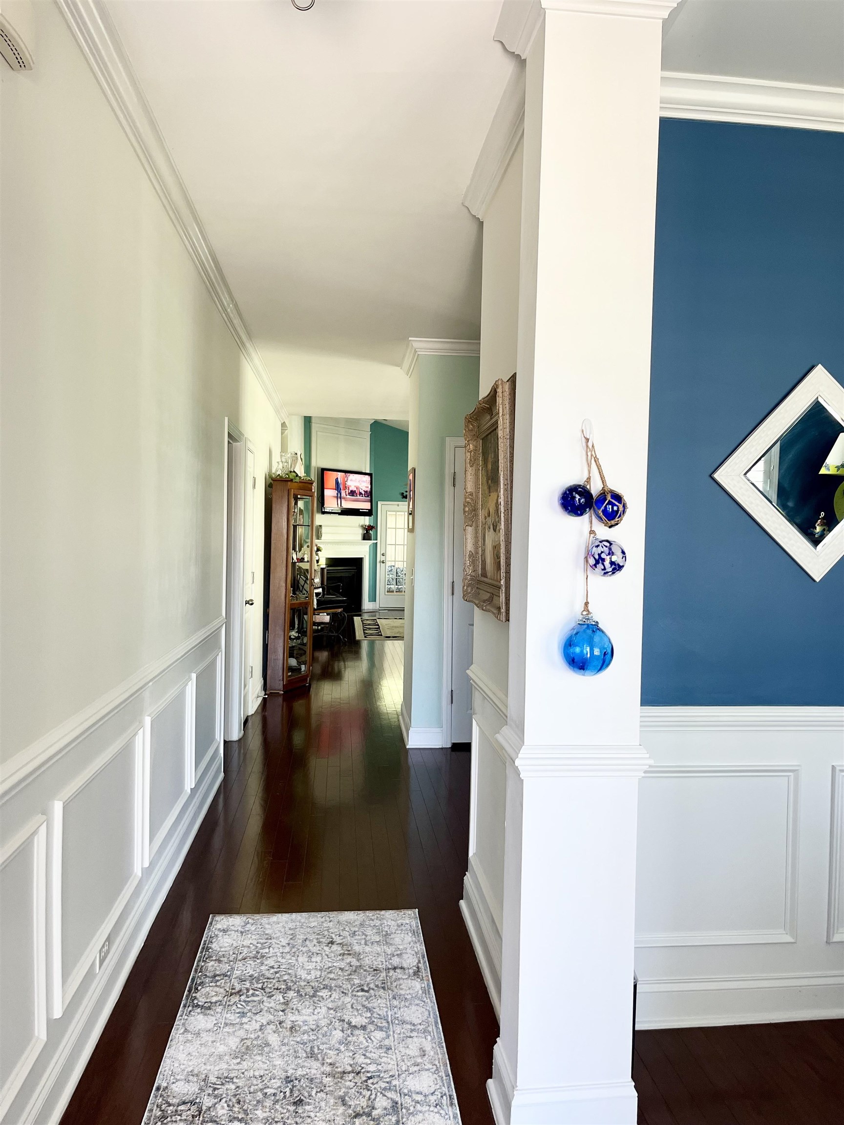 151 Coral Beach Circle Myrtle Beach, SC 29575 - Photo 5 of 40 Corridor with a decorative wall, dark wood finished floors, wainscoting, and crown molding