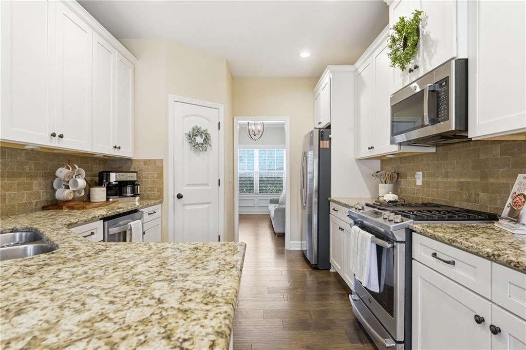 266 Cobblestone Trail Dallas, GA 30132 - Photo 11 of 49 a kitchen with stainless steel appliances granite countertop a stove top oven a refrigerator a sink and dishwasher