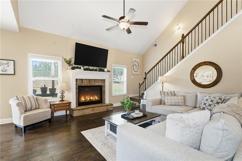 266 Cobblestone Trail Dallas, GA 30132 - Photo 12 of 49 a living room with furniture a flat screen tv and a fireplace