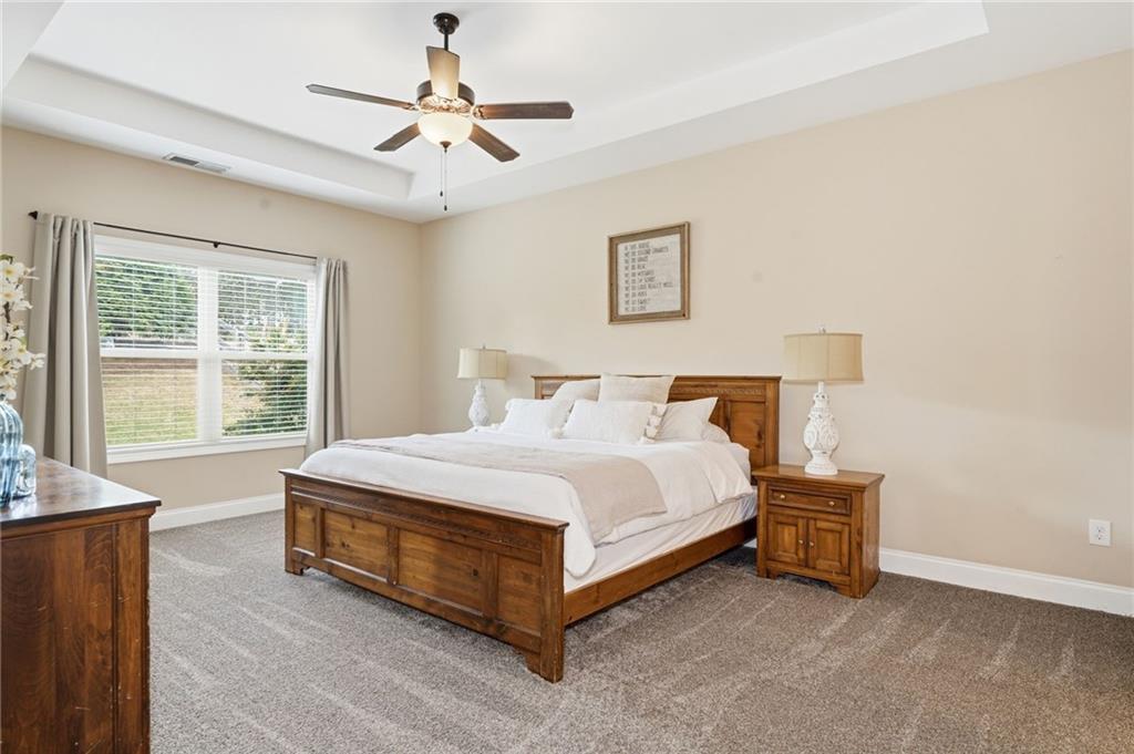 266 Cobblestone Trail Dallas, GA 30132 - Photo 21 of 49 a bed sitting in a spacious bedroom next to a window