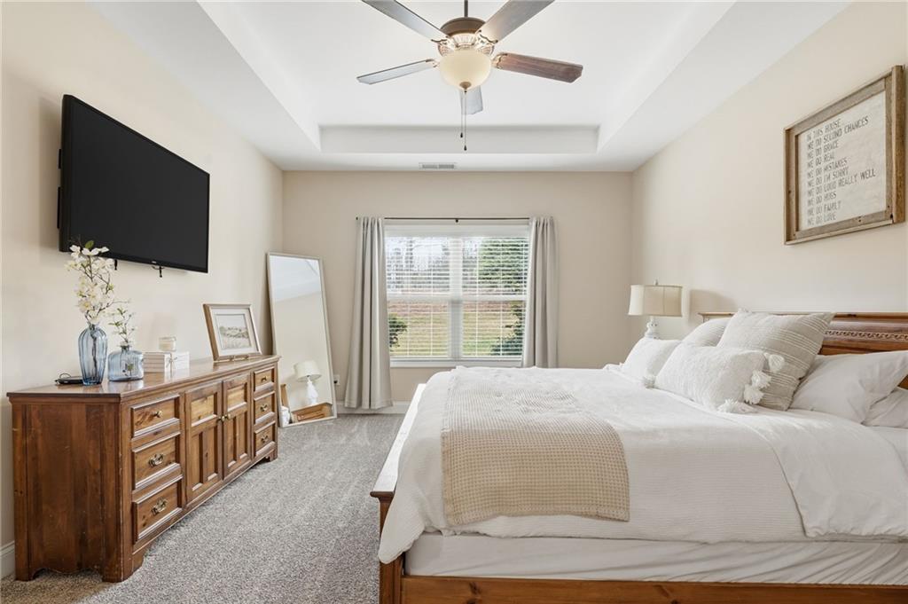 266 Cobblestone Trail Dallas, GA 30132 - Photo 22 of 49 a bedroom with a bed and a flat screen tv