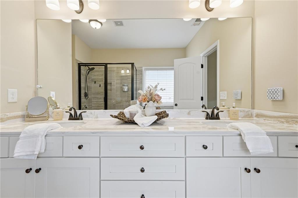 266 Cobblestone Trail Dallas, GA 30132 - Photo 23 of 49 a bathroom with a granite countertop sink double vanity and mirror