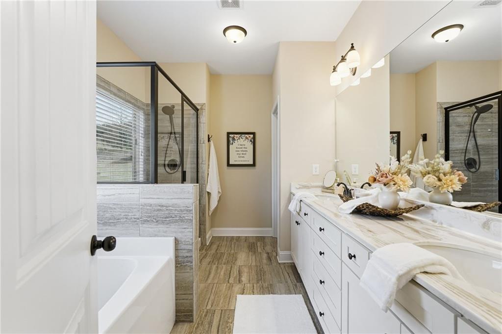 266 Cobblestone Trail Dallas, GA 30132 - Photo 24 of 49 a bathroom with a tub sink and mirror