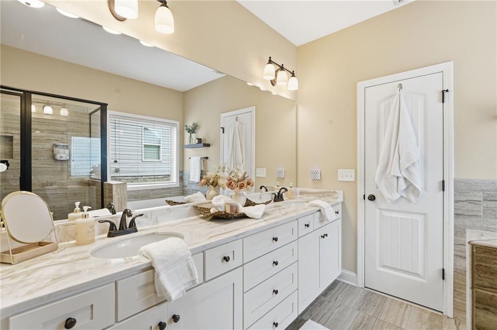 266 Cobblestone Trail Dallas, GA 30132 - Photo 25 of 49 a bathroom with double vanity sinks a mirror and a shower