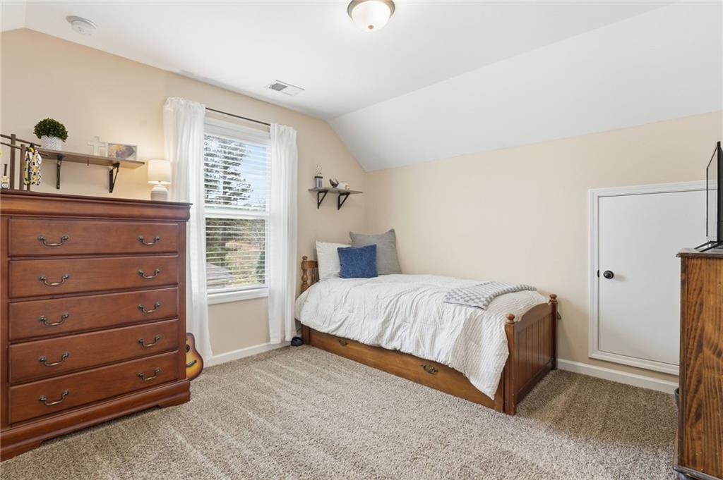 266 Cobblestone Trail Dallas, GA 30132 - Photo 30 of 49 a bedroom with a bed and a dresser