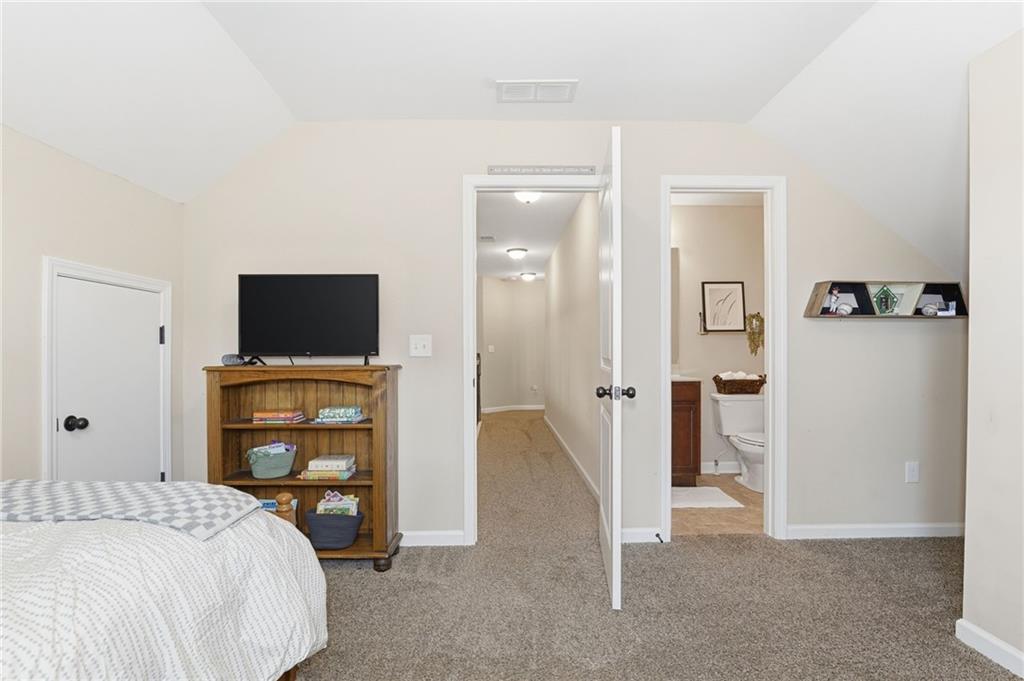266 Cobblestone Trail Dallas, GA 30132 - Photo 31 of 49 a bedroom with a bed and a television in it