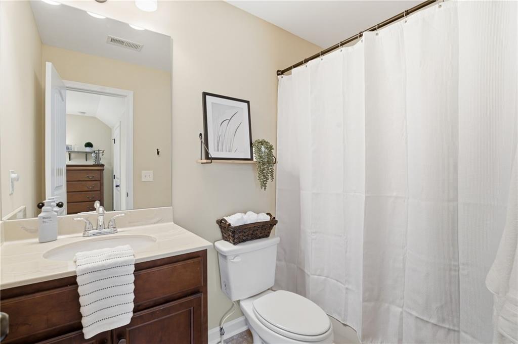 266 Cobblestone Trail Dallas, GA 30132 - Photo 32 of 49 a bathroom with a sink a toilet and shower curtain