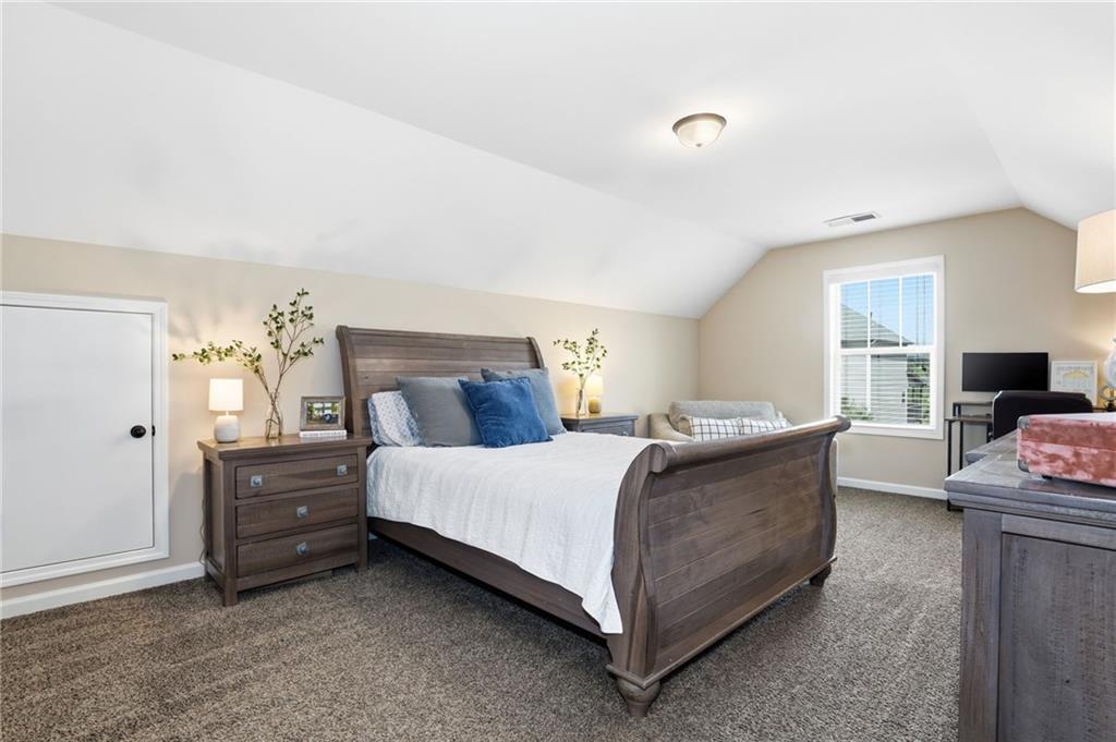 266 Cobblestone Trail Dallas, GA 30132 - Photo 34 of 49 a bedroom with a bed and a couch