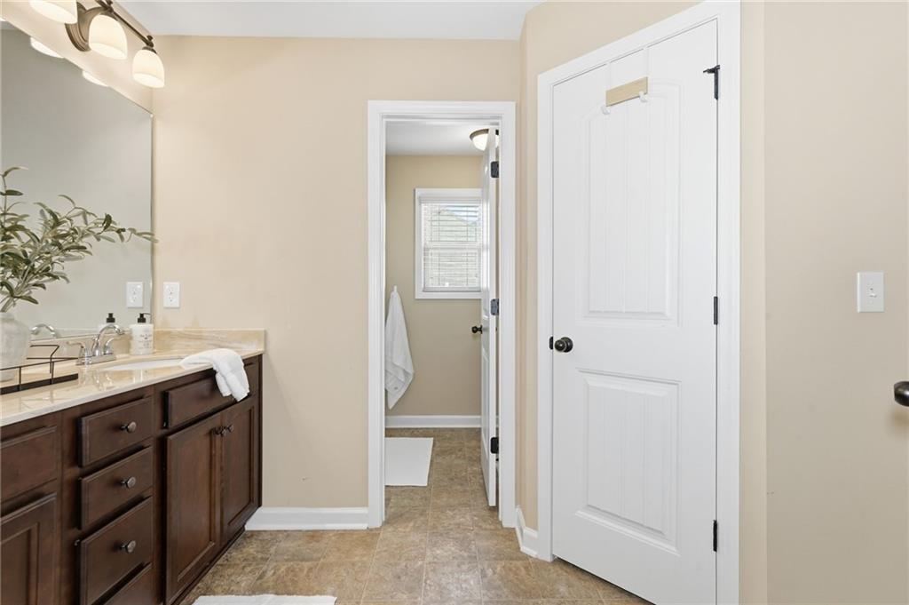 266 Cobblestone Trail Dallas, GA 30132 - Photo 35 of 49 a bathroom with a granite countertop sink and a mirror